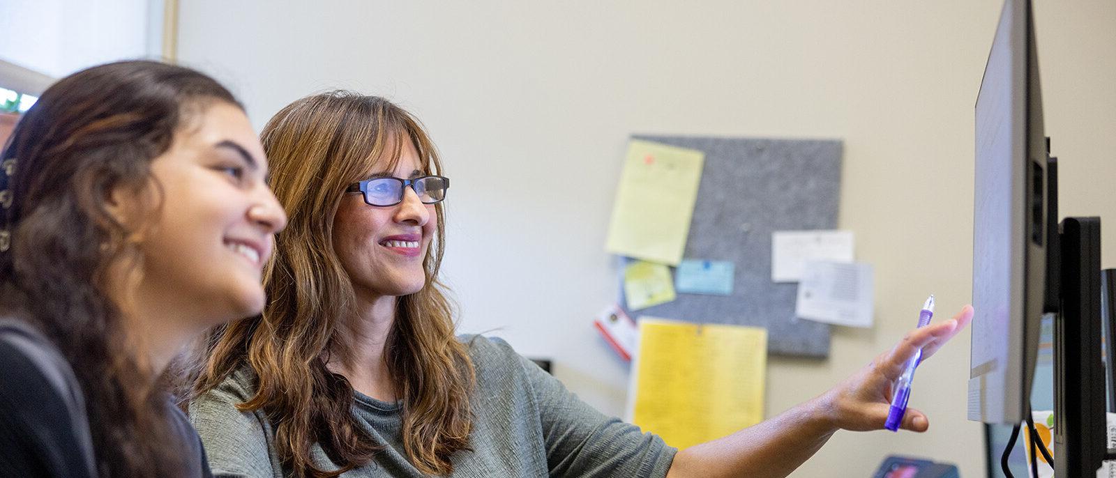 Female advisor working with female student